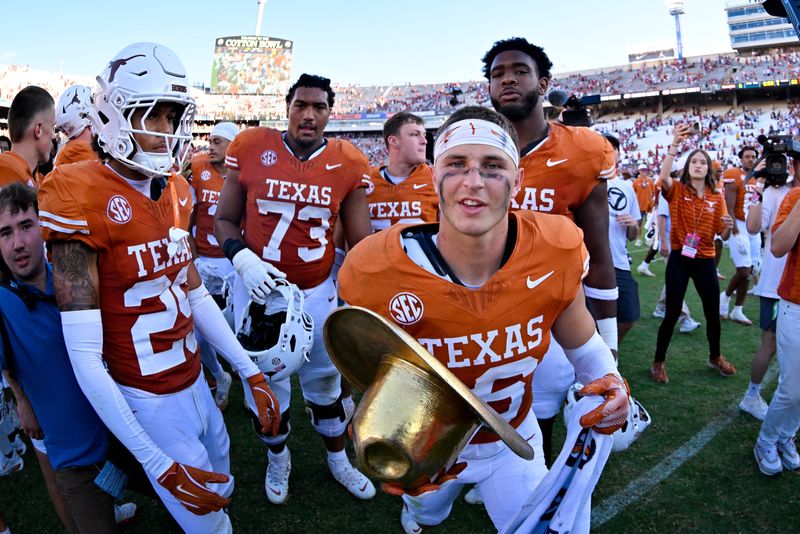 Oct 11, 2025; Dallas, Texas, USA; Texas Longhorns defensive back Michael Taaffe (16) celebrates with the golden hat after the Longhorns defeat the Oklahoma Sooners at the Cotton Bowl. Mandatory Credit: Jerome Miron-Imagn Images