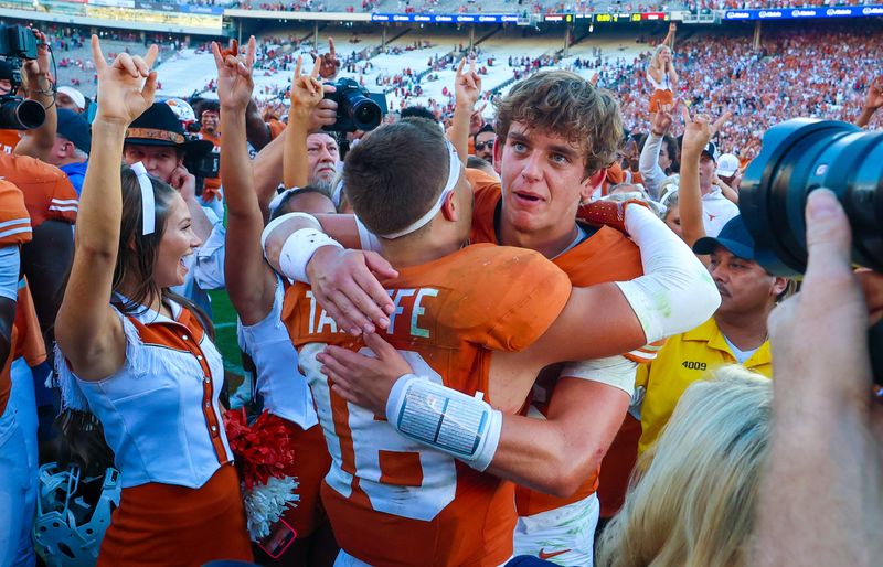 Oct 11, 2025; Dallas, Texas, USA; Texas Longhorns quarterback Arch Manning (16) hugs Texas Longhorns defensive back Michael Taaffe (16) after the game against the Oklahoma Sooners at the Cotton Bowl. Mandatory Credit: Kevin Jairaj-Imagn Images