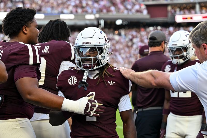 Oct 11, 2025; College Station, Texas, USA; Texas A&M Aggies wide receiver Mario Craver (1) is congratulated on the sideline after scoring a touchdown during the first half against the Florida Gators at Kyle Field. Mandatory Credit: Maria Lysaker-Imagn Images