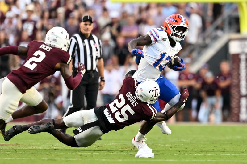 Oct 11, 2025; College Station, Texas, USA; Texas A&M Aggies safety Dalton Brooks (25) attempts to tackle Florida Gators running back Jadan Baugh (13) during the first half at Kyle Field. Mandatory Credit: Maria Lysaker-Imagn Images