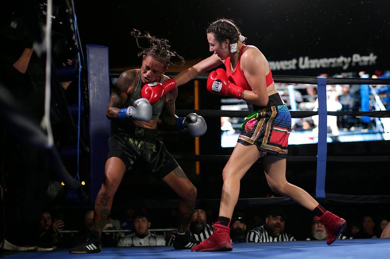 Sarah Click takes a straight punch from fight winner Ivy Enriquez during their bout at Southwest University Park in El Paso, Texas, Saturday, Oct. 11, 2025.
