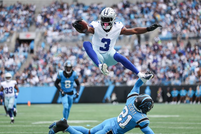 Oct 12, 2025; Charlotte, North Carolina, USA; Dallas Cowboys wide receiver George Pickens (3) jumps over Carolina Panthers safety Nick Scott (21) during the first quarter against the Carolina Panthers at Bank of America Stadium. Mandatory Credit: Cory Knowlton-Imagn Images