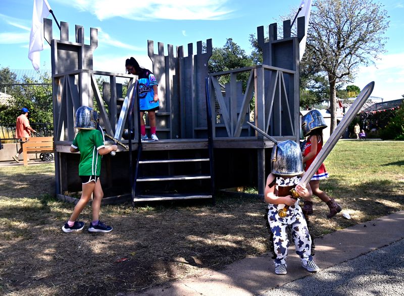 Michael Wuorinen, 2, prepares to storm the medieval castle set with his plastic sword as his sister Antonella, 3, crosses behind him along with other children at the Abilene Zoo Oct. 11. The final weekend for Boo at the Zoo will be Oct. 25-26.