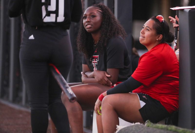 Texas Tech players NiJaree Canady and Victoria Valdez talk to Alana Johnson from the dugout during a intrasquad softball scrimmage, Tuesday, Oct. 14, 2025, at Rocky Jonson Field.