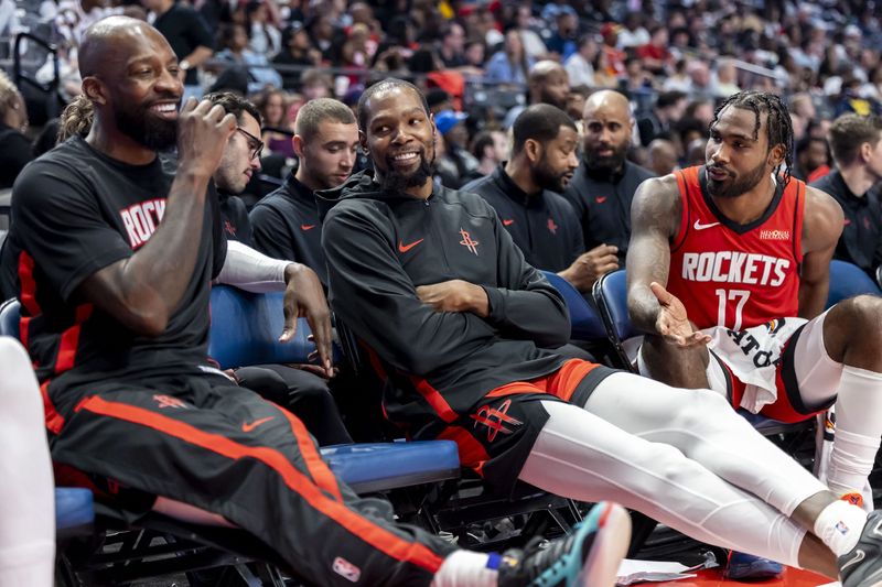 Oct 14, 2025; Birmingham, Alabama, USA; Houston Rockets forward Jeff Green and Houston Rockets forward Kevin Durant (7) and Houston Rockets forward Tari Eason (17) share a moment on the bench during the second half of an NBA preseason game against the New Orleans Pelicans at Legacy Arena at BJCC. Mandatory Credit: Vasha Hunt-Imagn Images