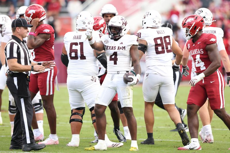 Oct 18, 2025; Fayetteville, Arkansas, USA; Texas A&M Aggies running back Rueben Owens II (4) celebrates after a first down in the first first quarter against the Arkansas Razorbacks at Donald W. Reynolds Razorback Stadium. Mandatory Credit: Nelson Chenault-Imagn Images