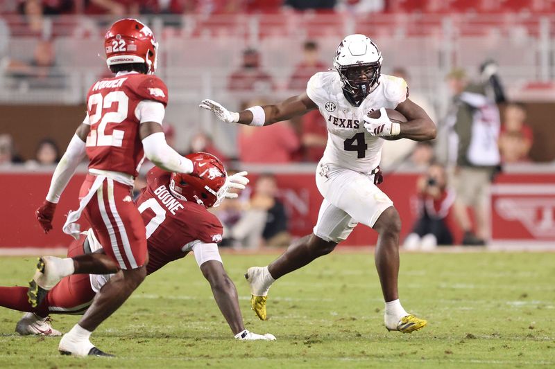 Oct 18, 2025; Fayetteville, Arkansas, USA; Texas A&M Aggies running back Rueben Owens II (4) rushes during the fourth quarter against the Arkansas Razorbacks at Donald W. Reynolds Razorback Stadium. Mandatory Credit: Nelson Chenault-Imagn Images