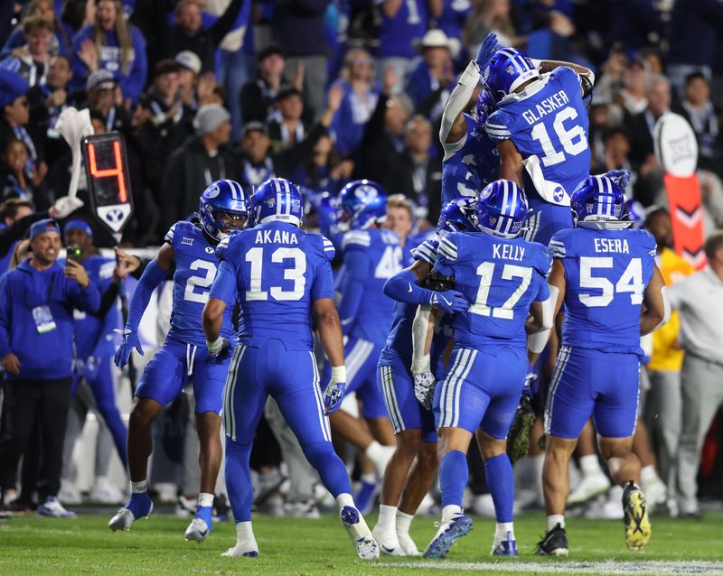 Oct 18, 2025; Provo, Utah, USA; BYU Cougars defense celebrate a fourth down stop against the Utah Utes during the second half at LaVell Edwards Stadium. Mandatory Credit: Rob Gray-Imagn Images