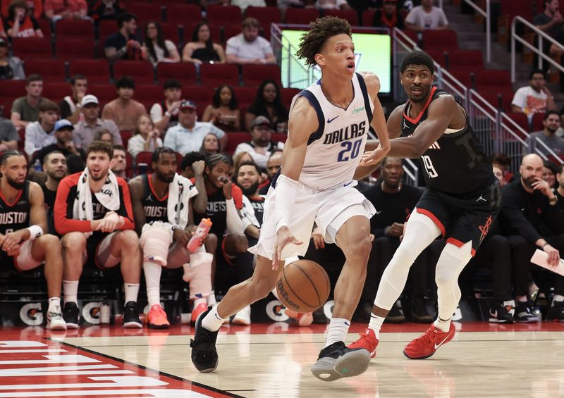Mar 14, 2025; Houston, Texas, USA; Dallas Mavericks forward Kessler Edwards (20) dribbles against Houston Rockets guard Nate Williams (19) in the second half at Toyota Center. Mandatory Credit: Thomas Shea-Imagn Images