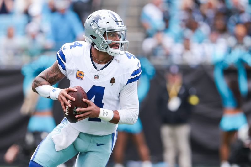 Dallas Cowboys quarterback Dak Prescott (4) looks for an open receiver during the first quarter against the Carolina Panthers at Bank of America Stadium in Charlotte, N.C. on Oct. 12, 2025.