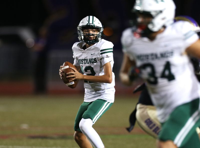King quarterback Tatum Emerson looks for an open receiver during a game against Miller on Thursday, Oct. 23, 2025