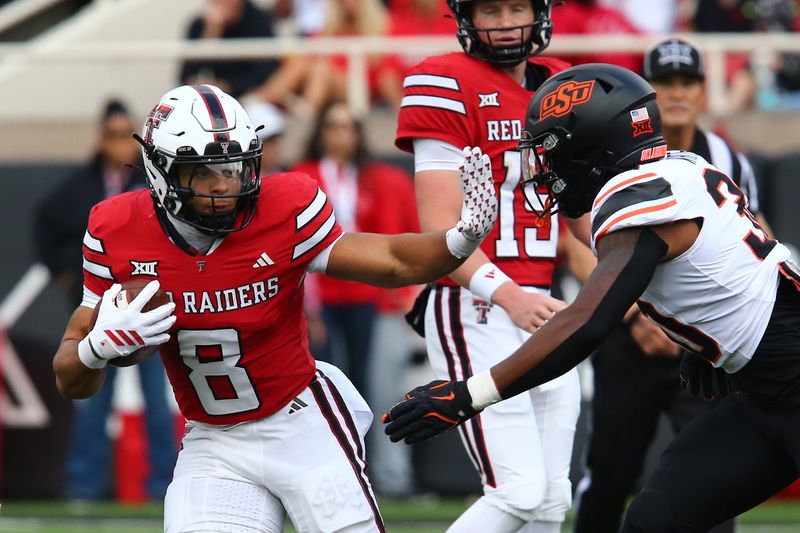 Oct 25, 2025; Lubbock, Texas, USA; Texas Tech Red Raiders running back Cameron Dickey (8) stiff arms Oklahoma State Cowboys defensive back Trip White (30) in the first half at Jones AT&T Stadium. Mandatory Credit: Michael C. Johnson-Imagn Images