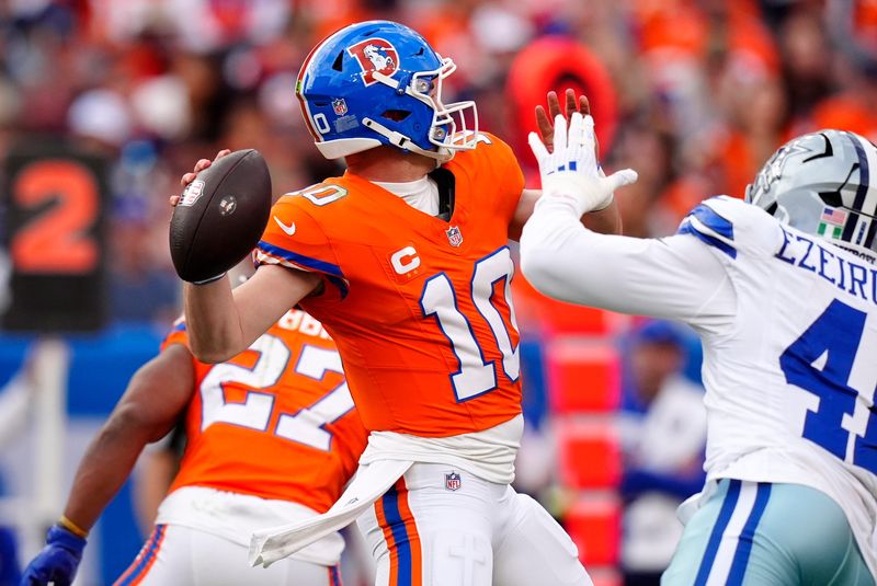 Oct 26, 2025; Denver, Colorado, USA; Denver Broncos quarterback Bo Nix (10) throws a pass against Dallas Cowboys defensive end Donovan Ezeiruaku (41) in the second half at Empower Field at Mile High. Mandatory Credit: Ron Chenoy-Imagn Images