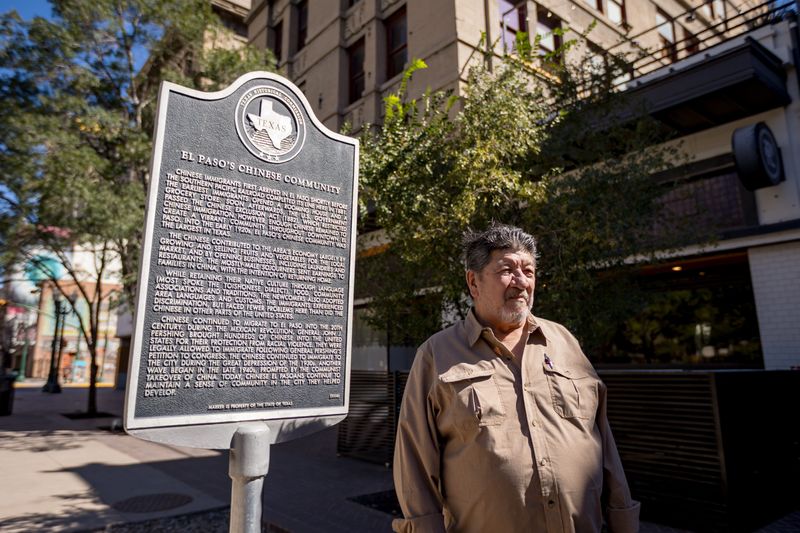 Claudia Ley’s father stands by a Texas Historical Commission marker about El Paso’s Chinese community outside the Banner Building, across from San Jacinto Plaza in downtown El Paso, Texas, where he worked in the 1970s, on Friday, Oct. 24, 2025.