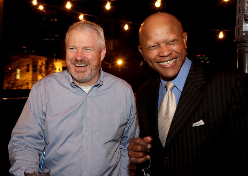 Seattle mayor Mike McGinn (L) talks with former NBA player Donald Earl "Slick" Watts of the Supersonics at a re-election concert and rally in the Capitol Hill neighborhood of Seattle, Washington November 1, 2013. REUTERS/Jason Redmond (UNITED STATES - Tags: POLITICS SPORT BASKETBALL ELECTIONS)