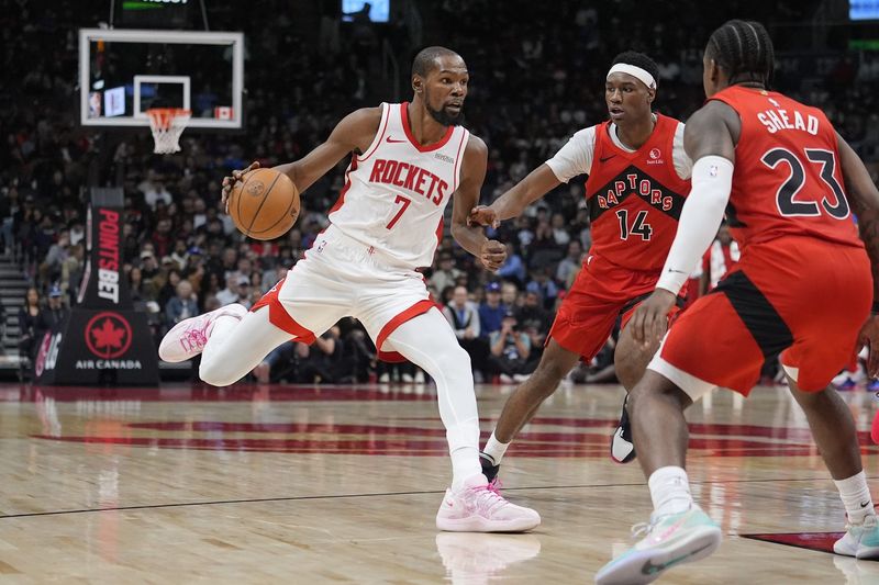 Oct 29, 2025; Toronto, Ontario, CAN; Houston Rockets forward Kevin Durant (7) drives to the net against Toronto Raptors guard Ja'Kobe Walter (14) and guard Jamal Shead (23) during the second half at Scotiabank Arena. Mandatory Credit: John E. Sokolowski-Imagn Images