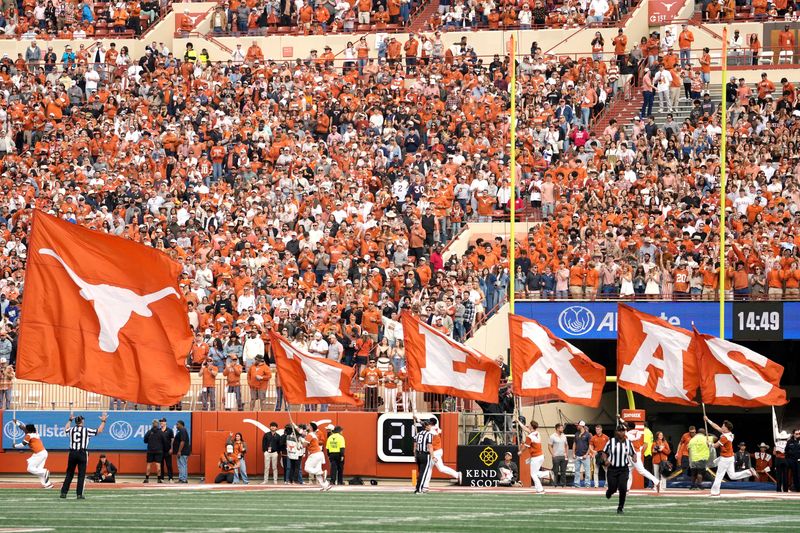 Nov 1, 2025; Austin, Texas, USA; Texas Longhorns cheerleaders carry flags on the field after a touchdown during the first half against the Vanderbilt Commodores at Darrell K Royal-Texas Memorial Stadium. Mandatory Credit: Scott Wachter-Imagn Images