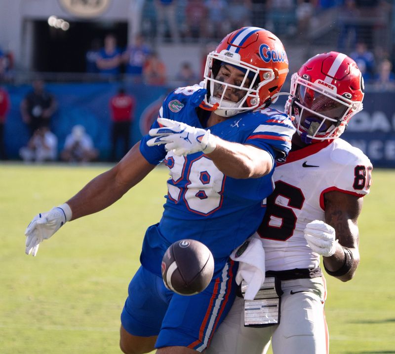 Florida Gators defensive back Devin Moore (28) almost intercepts a ball intended for Georgia Bulldogs wide receiver Dillon Bell (86) in the second quarter in an NCAA football game, Saturday, Nov. 1, 2025, at EverBank Stadium in Jacksonville, Fla. [Doug Engle/Florida Times-Union]