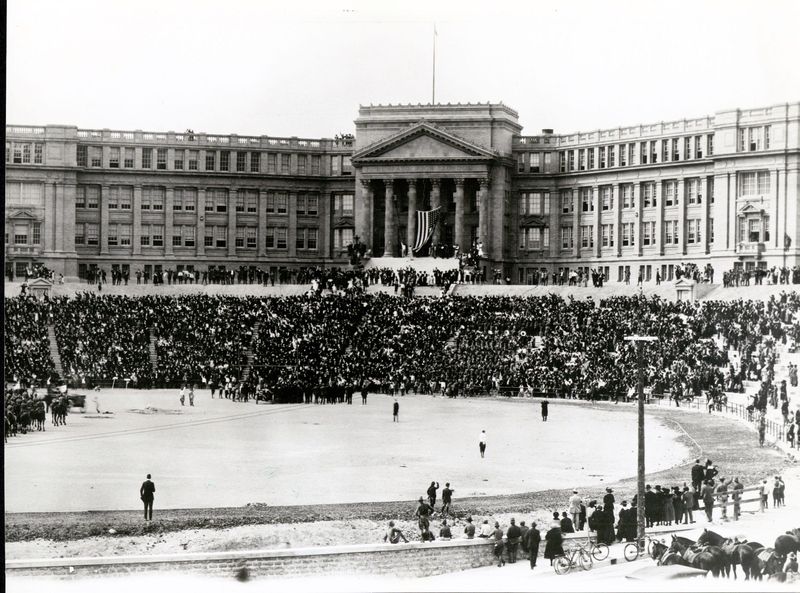 FIRST EP ARMISTICE DAY: A joyous crowd, led by James A. Dick, pledges Allegiance to the Flag as the 11:30 a.m. ceremony gets under way at El Paso High School Stadium on Nov. 11, 1918. Four troops of the 5th Cavalry, and the regimental band participated in the program, which included prayers, community singing and patriotic speeches, including a speech by Judge W. A. Hawkins. A spontaneous crowd of citizens gathered at the stadium soon after hearing of the Armistice, and following a parade the morning of Nov. 11, held the ceremony shown in the photo. The Rev. Fuller A. Smith led the crowd in reciting the Lord's Prayer, and the group sang the Battle Hymn of the Republic and other songs. That night, at a huge bonfire at 8 p.m., they gathered again at the stadium and twice burned the Kaiser in effigy. The crowds were estimated at more than 10,000. The ceremony shown in the photo followed a huge parade in Downtown El Paso which took an hour to pass a given point.