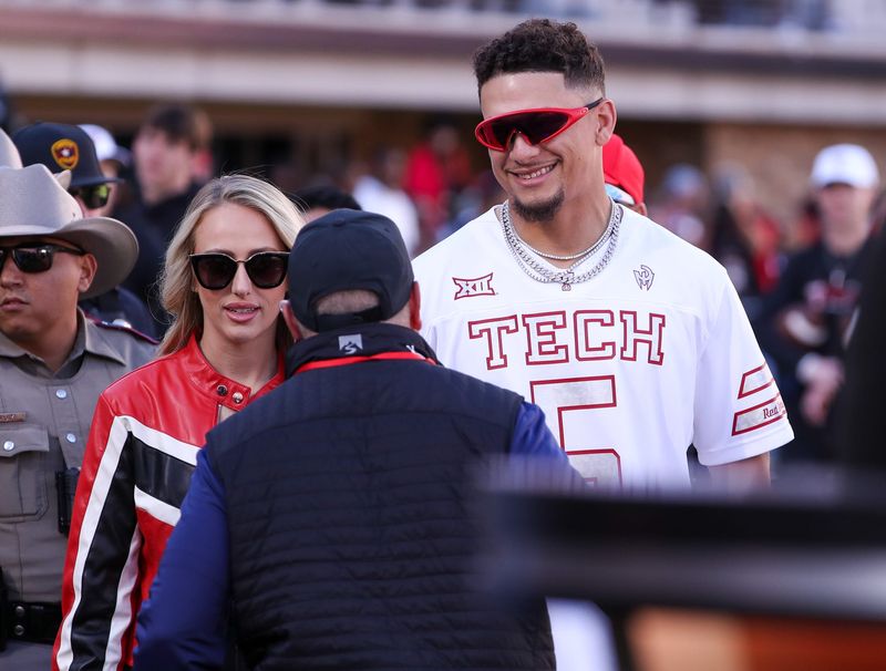 Texas Tech alum Patrick Mahomes and his wife, Brittany Mahomes, make their way to the College GameDay set before a Big 12 Conference football game, Saturday, Nov. 8, 2025, at Jones AT&T Stadium.