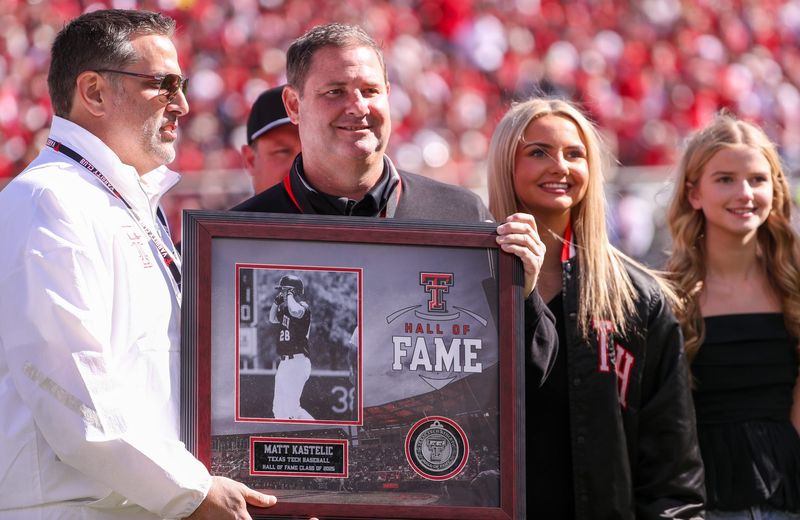 Texas Tech athletics Hall of Fame inductee Matt Kastelic, center, is honored at halftime of a Big 12 football game on Nov. 8, 2025, at Jones AT&T Stadium.