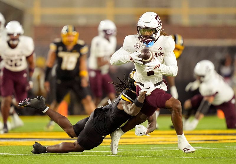 Nov 8, 2025; Columbia, Missouri, USA; Texas A&M Aggies wide receiver Mario Craver (1) runs with the ball against Missouri Tigers cornerback Toriano Pride Jr. (2) during the second half at Faurot Field at Memorial Stadium. Mandatory Credit: Jay Biggerstaff-Imagn Images