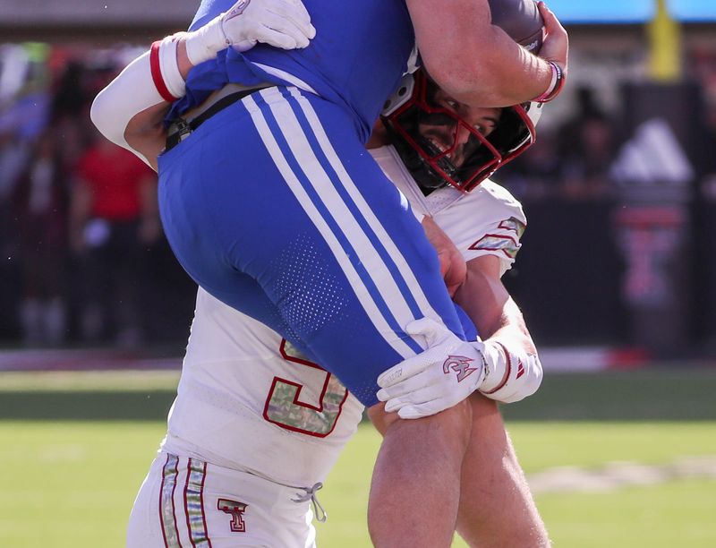 Texas Tech's Cole Wisniewski tackles an air-borne Bear Bachmeier of BYU during a Big 12 Conference football game, Saturday, Nov. 8, 2025, at Jones AT&T Stadium.