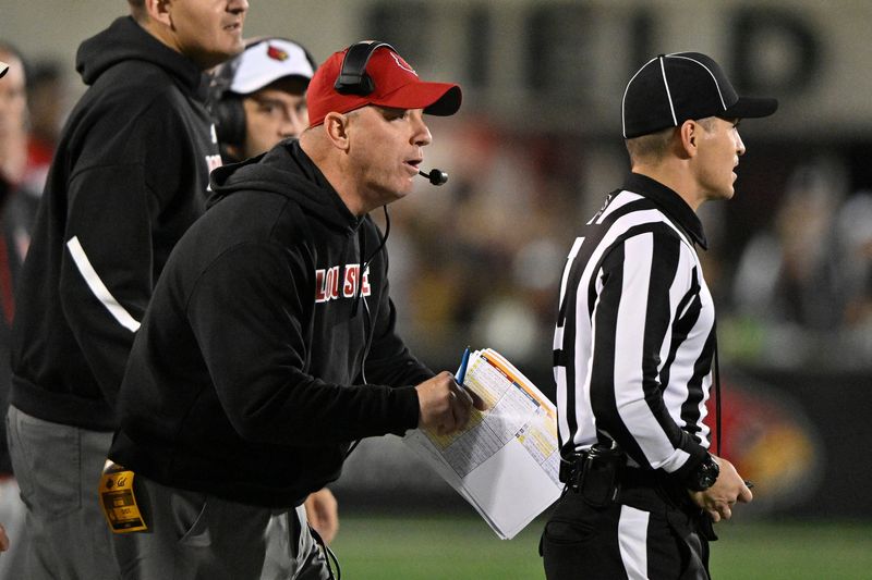 Nov 8, 2025; Louisville, Kentucky, USA; Louisville Cardinals head coach Jeff Brohm talks with an official during the second half against the California Golden Bears at L&N Federal Credit Union Stadium. California defeated Louisville 29-26. Mandatory Credit: Jamie Rhodes-Imagn Images