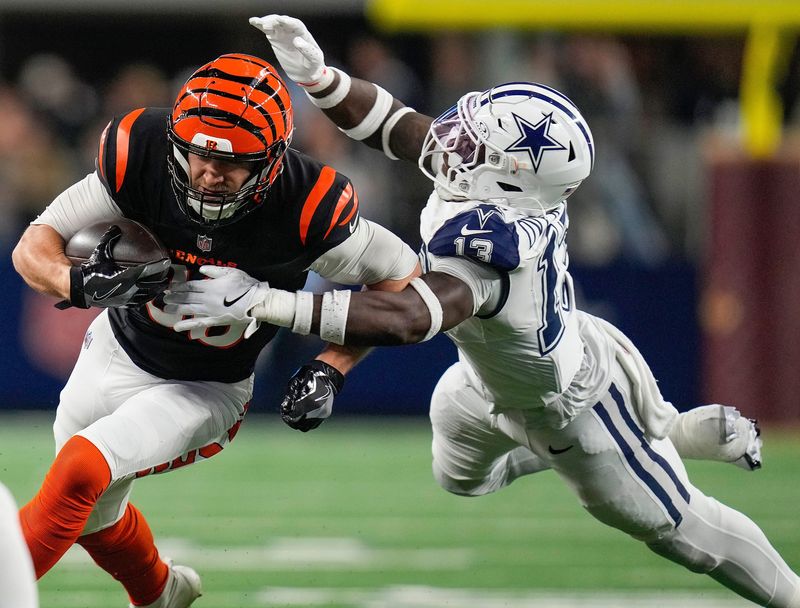 Cincinnati Bengals tight end Mike Gesicki (88) tries to break free from Dallas Cowboys linebacker DeMarvion Overshown (13) during the first half Monday Night Football at AT&T Stadium in Arlington,Texas on Monday, December 9, 2024.
