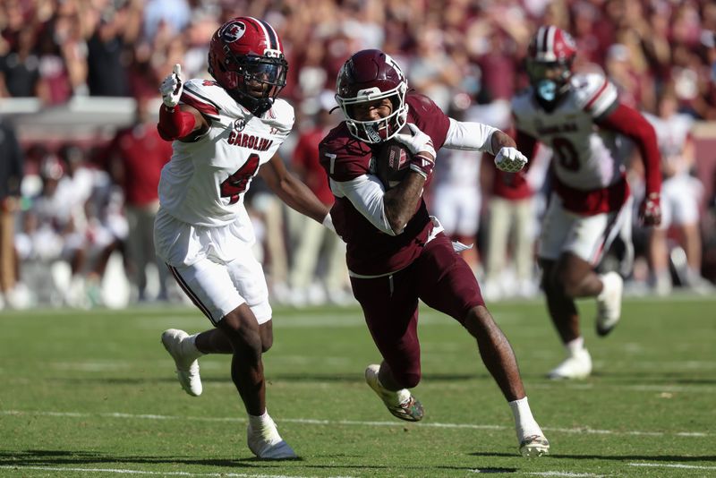 Nov 15, 2025; College Station, Texas, USA; Texas A&M Aggies wide receiver KC Concepcion (7) runs with the ball past South Carolina Gamecocks defensive back Vicari Swain (4) during the fourth quarter at Kyle Field. Mandatory Credit: Troy Taormina-Imagn Images