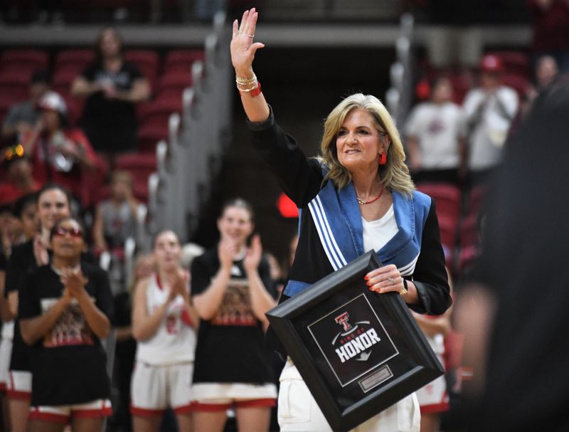 Texas Tech women's basketball coach and former player Krista Gerlich acknowledges the crowd during a Ring of Honor ceremony Sunday, Nov. 16, 2025, at United Supermarkets Arena. The 1993 Lady Raiders national-championship team was inducted.