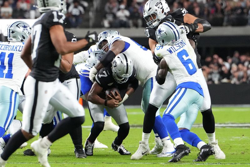 Nov 17, 2025; Paradise, Nevada, USA; Las Vegas Raiders quarterback Geno Smith (7) is sacked by Dallas Cowboys defensive tackle Kenny Clark (95) and defensive tackle Quinnen Williams (92) during the first half at Allegiant Stadium. Mandatory Credit: Stephen R. Sylvanie-Imagn Images