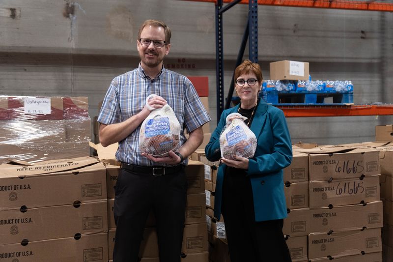 High Plains Food Bank Executive Director Zack Wilson and Pantex Senior Director of Communications Laura Bailey hold donated turkeys at the food bank warehouse in Amarillo on Tuesday, Nov. 18, 2025.