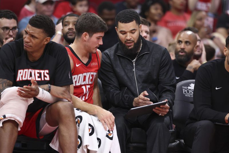 Nov 16, 2025; Houston, Texas, USA; Houston Rockets guard Reed Sheppard (15) talks with guard Fred VanVleet (right) on the bench during the game against the Orlando Magic at Toyota Center. Mandatory Credit: Troy Taormina-Imagn Images