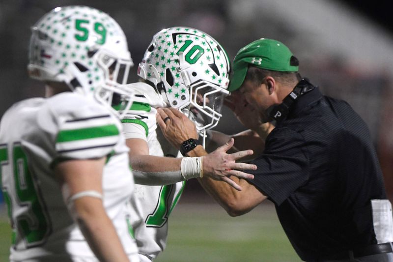 Ropes' Ryland Kieth (10) and Ropes football coach Beau Riker head-butt during the Class 2A Division II area playoff game against Farwell, Friday, Nov. 21, 2025, at Wildcat Stadium in Littlefield.