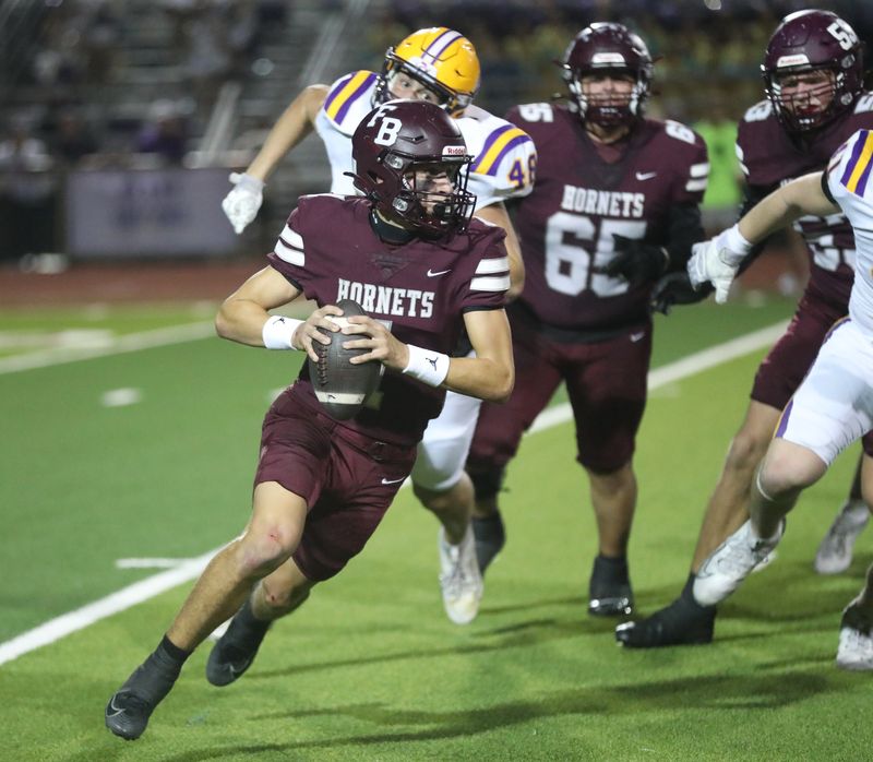 Flour Bluff quarterback Lucian Cruz evades a tackle before throwing a pass during Friday's Class 5A Division I area round playoff game against San Antonio Pieper.