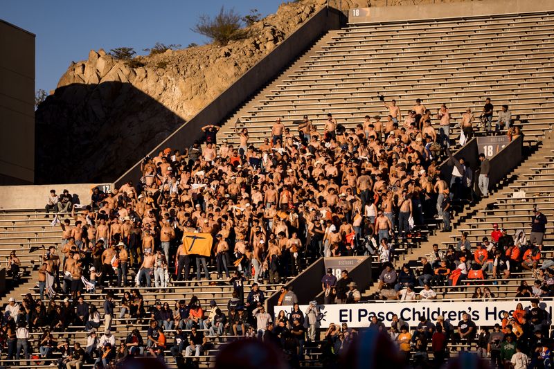 UTEP fans take off their shirts and wave them during the annual I-10 rivalry football game against NMSU at the Sun Bowl in El Paso, Texas, on Saturday, Nov. 22, 2025.
