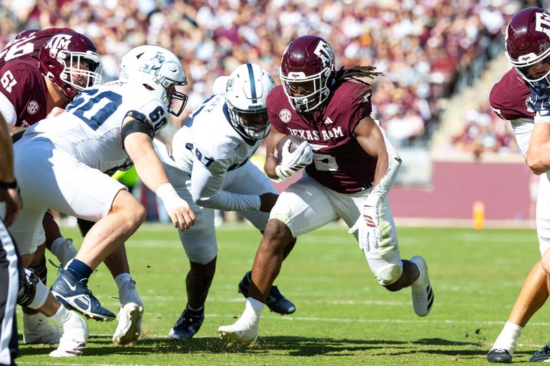 Nov 22, 2025; College Station, Texas, USA; Texas A&M Aggies running back Amari Daniels (5) runs with the ball in the first half of a game against the Samford Bulldogs at Kyle Field. Mandatory Credit: Joseph Buvid-Imagn Images