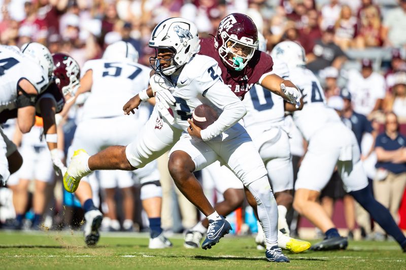 Nov 22, 2025; College Station, Texas, USA; Samford Bulldogs quarterback Quincy Crittendon (2) is sacked by Texas A&M Aggies defensive end Marco Jones (10) in the second half of a game at Kyle Field. Mandatory Credit: Joseph Buvid-Imagn Images