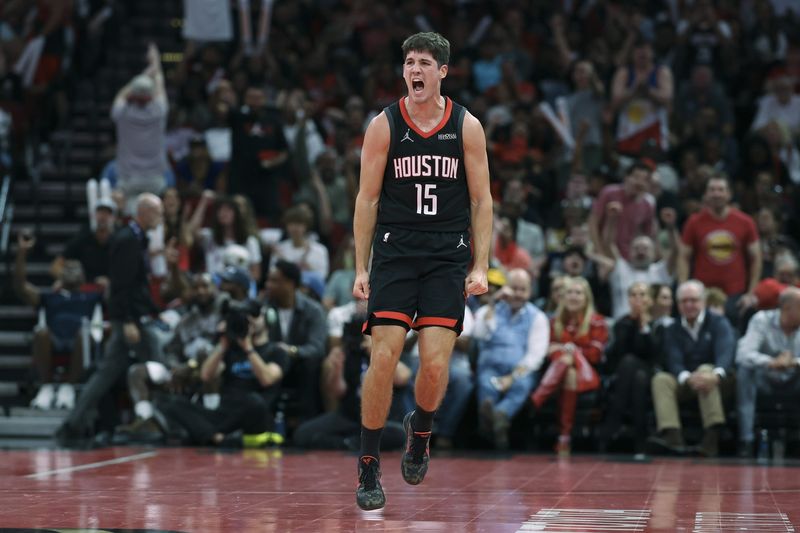 Nov 21, 2025; Houston, Texas, USA; Houston Rockets guard Reed Sheppard (15) reacts after scoring a baskset during the second quarter against the Denver Nuggets at Toyota Center. Mandatory Credit: Troy Taormina-Imagn Images