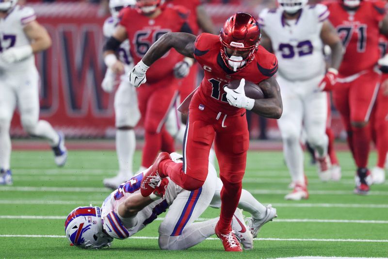 Nov 20, 2025; Houston, Texas, USA; Houston Texans wide receiver Nico Collins (12) runs against Buffalo Bills safety Cole Bishop (24) in the second quarter at NRG Stadium. Mandatory Credit: Troy Taormina-Imagn Images