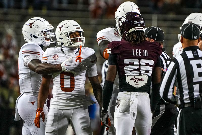 Nov 30, 2024; College Station, Texas, USA; Texas Longhorns receiver DeAndre Moore Jr. (0) gets into a verbal argument with Texas A&M defensive back Will Lee III (26) during the Lone Star Showdown at Kyle Field. Mandatory Credit: Sara Diggins/USA TODAY Network via Imagn Images
