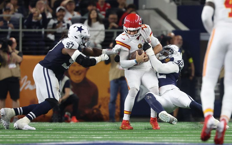 Nov 27, 2025; Arlington, Texas, USA; Dallas Cowboys defensive end Jadeveon Clowney (42) and Dallas Cowboys defensive tackle Osa Odighizuwa (97) pressure Kansas City Chiefs quarterback Patrick Mahomes (15) during the fourth quarter at AT&T Stadium. Mandatory Credit: Kevin Jairaj-Imagn Images