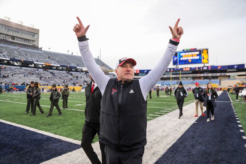 Nov 29, 2025; Morgantown, West Virginia, USA; Texas Tech Red Raiders head coach Joey McGuire celebrates with fans after defeating the West Virginia Mountaineers at Milan Puskar Stadium. Mandatory Credit: Ben Queen-Imagn Images