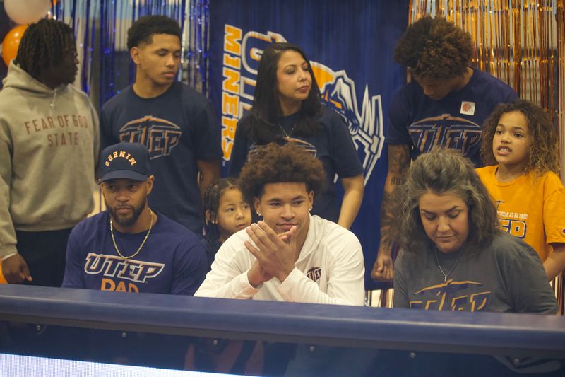 West Plains' Kane White-Tinsley sits with his family and friends before signing to play football at UTEP on Dec. 3, 2025.
