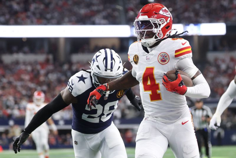 Kansas City Chiefs wide receiver Rashee Rice (4) runs with the ball past Dallas Cowboys safety Malik Hooker (28) during the first quarter at AT&T Stadium in Arlington, Texas on Nov. 27, 2025.