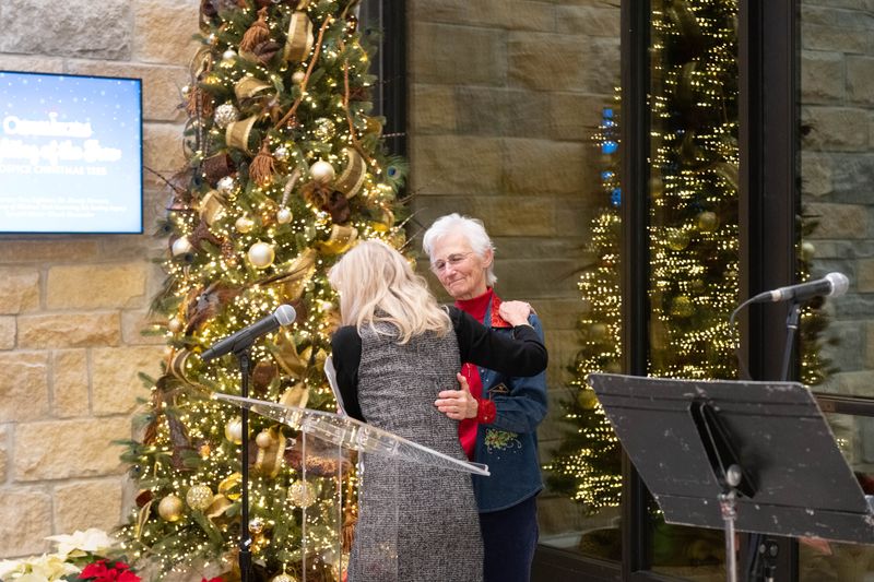 Cindy Terk, chairperson of Olivia’s Angels, hugs Davlyn Duesterhaus during the Lighting of the Tree ceremony on Dec. 2 at the Harrington Cancer and Health Foundation in Amarillo.