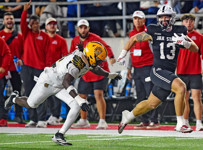 Jax State's Pearson Baldwin tries to evade the tackle of Kennesaw State's Donovan Westmoreland during college school football action at AmFirst Stadium in Jacksonville, Alabama November 15, 2025. (Dave Hyatt / Hyatt Media LLC)