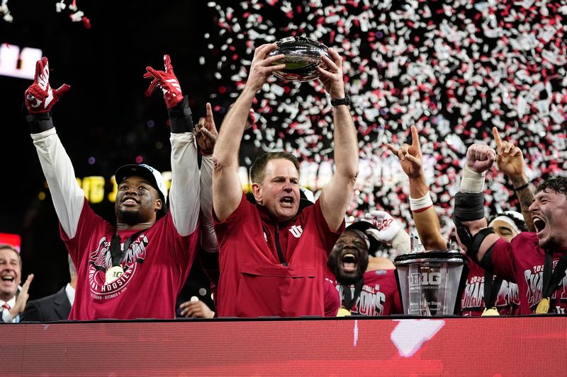 Indiana Hoosiers head coach Curt Cignetti hoists the trophy after winning the Big Ten Conference championship game against the Ohio State Buckeyes at Lucas Oil Stadium in Indianapolis on Dec. 6, 2025. Ohio State lost 13-10.