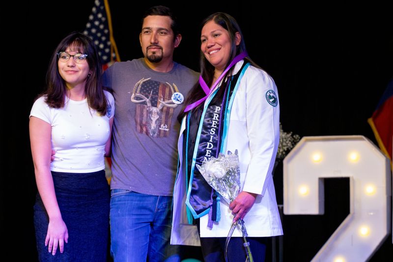 Patricia Cruz, Student Nurses Association president, is pinned by her husband, David Cruz, and daughter, Camila Cruz, during EPCC’s vocational nurse pinning ceremony at the Administrative Services Center Auditorium in El Paso, Texas, on Dec. 11, 2025.